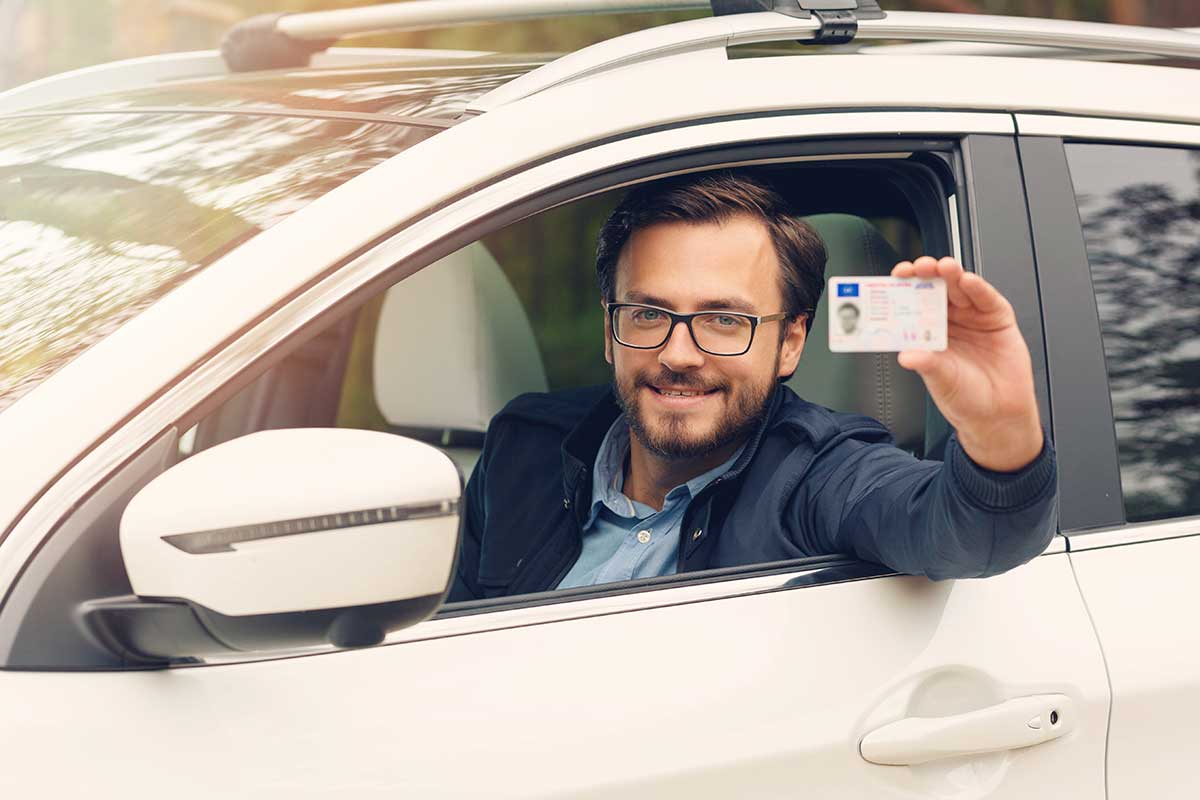 Driver Holding up His Restored License