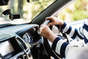 Driver's hands on the car wheel after getting their revoked Michigan license back