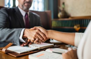 Person shaking hands with a suspended license lawyer in Michigan after agreement