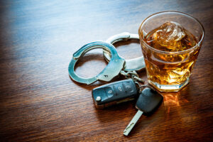 photo of keys, alcohol, and handcuffs