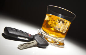 photo of car keys and whiskey