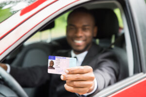 photo of a man holding a reinstated license