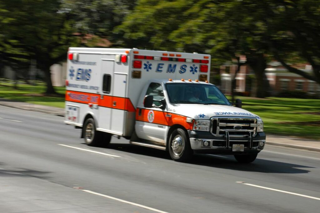 an ambulance speeding down a road