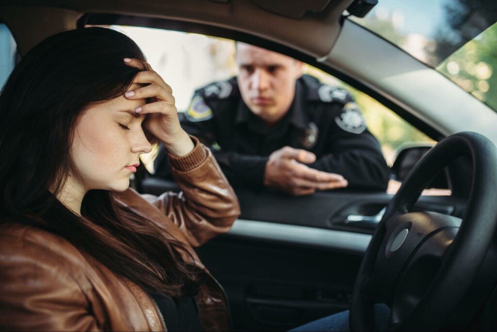 a woman looking distressed after being pulled over