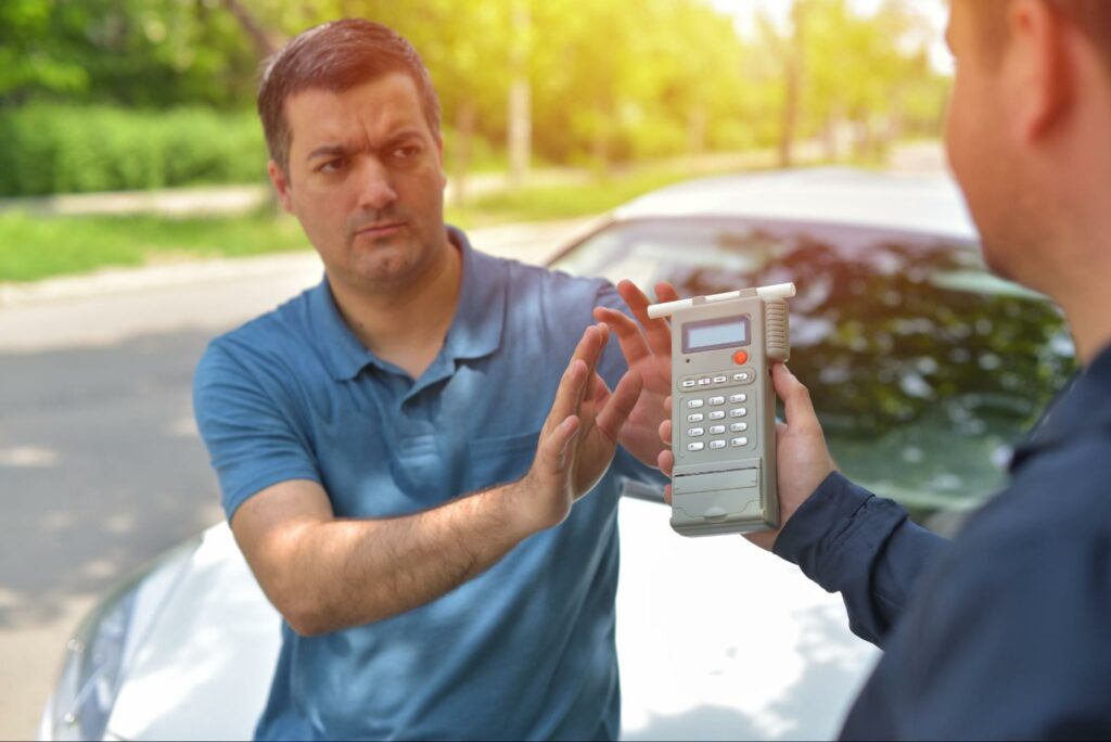 Man refusing a breathalyzer test from a police officer